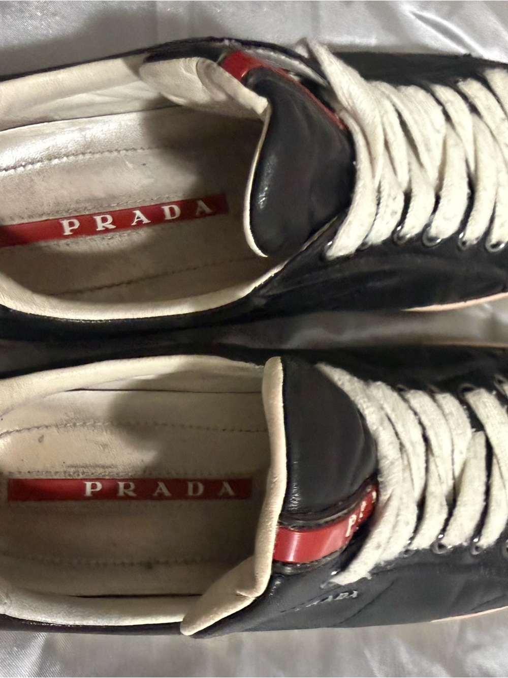 Prada Black Leather Sneakers with White Laces and Red Logo
